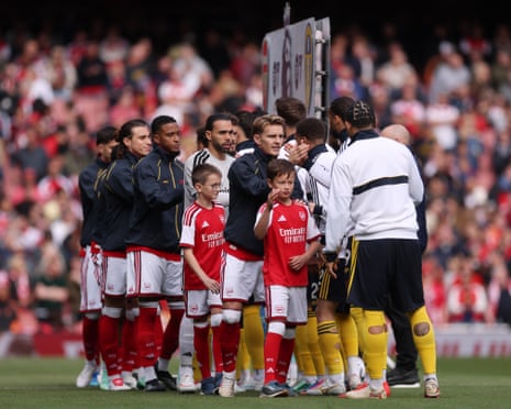 Martin Odegaard and David Raya of Arsenal shake hands with Leeds United players.
