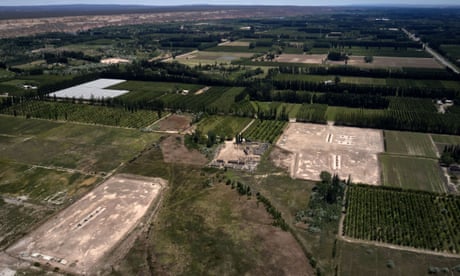 An aerial view of gas wells in a patchwork of fields