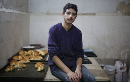 Mohammed Omran Injeela, aged 20, works in a shop selling pastries in al-Bab, Syria.