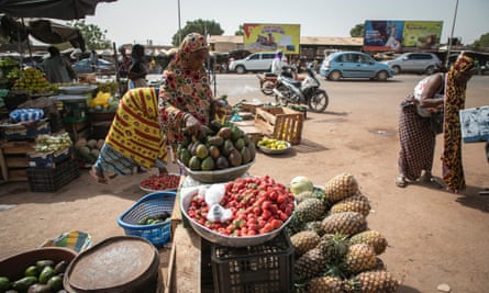 Woman selling strawberries at roadside