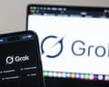 The Grok artificial intelligence (AI) tool displayed on a mobile phone and laptop