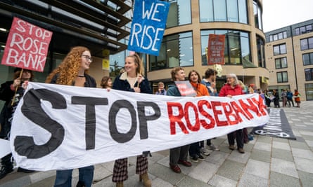 About eight people holding a long banner reading: ‘Stop Rosebank’. Two also hold signs reading: ‘Stop Rosebank’ and ‘We rise’