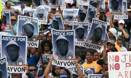 Protesters hold signs during a march and rally for Trayvon Martin in 2012.