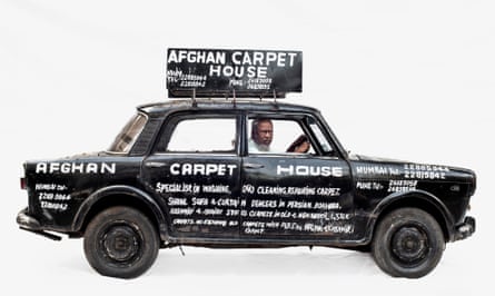 Carpet repair man Abdul in his Premier in Mumbai, India. His car is black with Afghan Carpet House and other things written on it in white