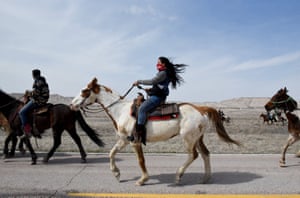Stephanie Big-Eagle rides with other Fort Laramie treaty riders along Bombing Range Road on the Pine Ridge reservation.