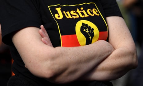 Woman wearing T-shirt with the Aboriginal flag and the word 'Justice"