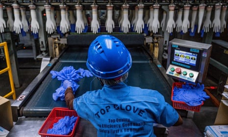 A worker inspects disposable gloves at the Top Glove factory in Shah Alam on the outskirts of Kuala Lumpur. The US will seize products made by Malaysia’s Top Glove, officials said on 29 March.