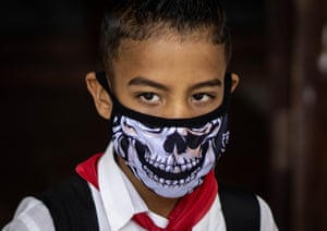 A student wears a mask after school in Havana