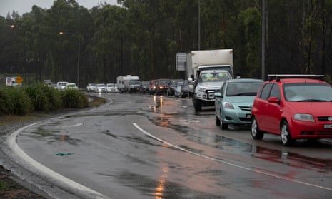 Traffic lined up at the Pacific Highway roadblock outside Taree NSW wait to resume their journey north late on Sunday afternoon. Sunday 21st March 2021. Photograph by Mike Bowers. Guardian Australia.