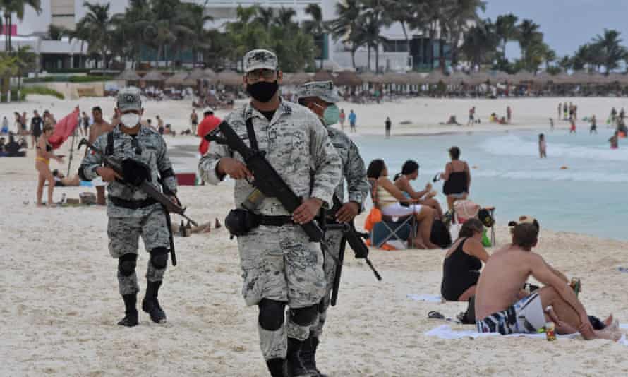 Members of the National Guard's new tourist security battalion patrol a beach in Cancun, on the Tulum coast.