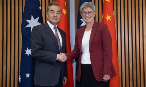Penny Wong shakes hands with China's foreign minister Wang Yi at Parliament House this morning.