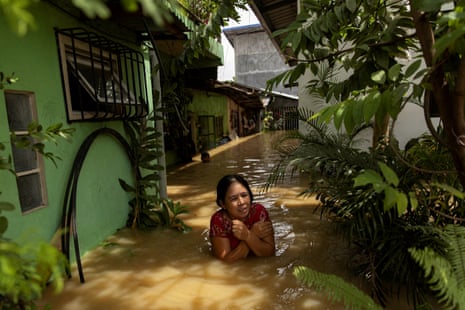 A woman wades through chest-deep flood after Super Typhoon Noru, in San Ildefonso, Bulacan province, the Philippines on 26 September