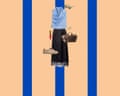 A composite image of a pale blue silky sleeveless top with a high neck, olive green sunglasses, gold ring, brown utility style bag, black silk midi skirt with a lace trim, beige trainers and red lip gloss on a peach and blue vertically striped background