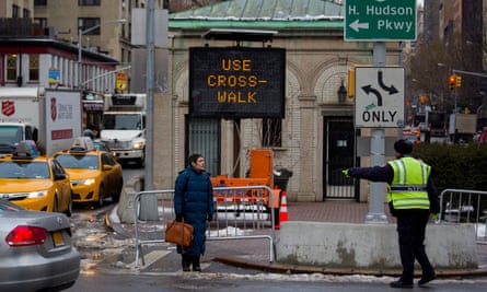 A pedestrian is given direction to a crosswalk by a traffic agent at W. 96th Street and Broadway in the Upper West Side of New York