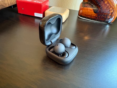 Open earbuds let you tune in without tuning out the world. Here are the five best pairs | headphones Earbuds in case on table
