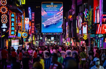 Pedestrians walk past a sign welcoming the arrival of US service personnel in Pattaya