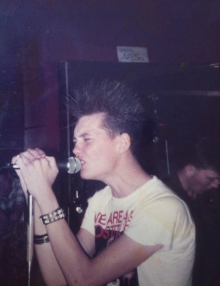 Keith Martin, aged 17, performing at a youth club in Irvine new town in his We Are All Prostitutes T-shirt, 1983.