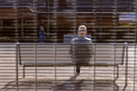 John sitting on a bench with his back to the camera.