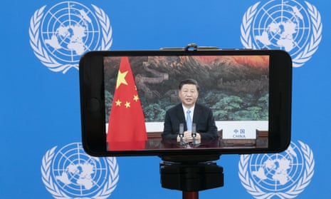 Chinese President Xi Jinping is seen on a phone screen remotely addressing the 75th session of the United Nations General Assembly