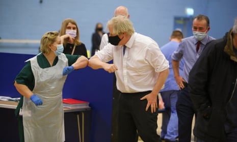 Boris Johnson touches elbows with a nurse during a visit to a vaccination centre in Cwmbran, south Wales. 