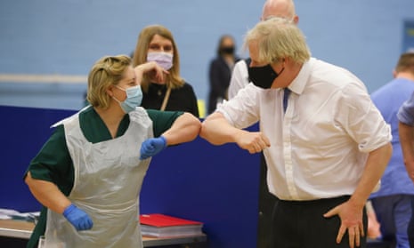 Boris Johnson touches elbows with a nurse at a vaccination centre