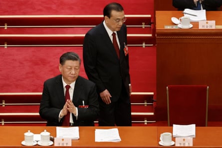 Li Keqiang returns to his seat next to Xi Jinping at the opening session of the National People’s Congress