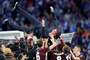 Players of Leicester City throw Brendan Rodgers in the air.