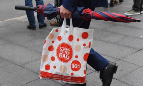 Shopper holding Coles bag