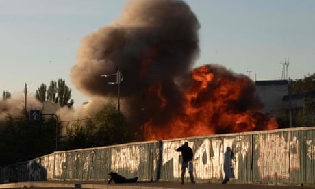 A man falls on the ground following a drone attack in Kyiv on Monday.