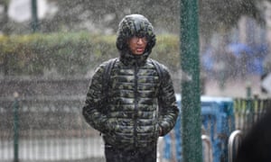 Morning commuters make their way through heavy rain in Birmingham.