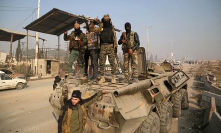 Syrian fighters on an armoured vehicle