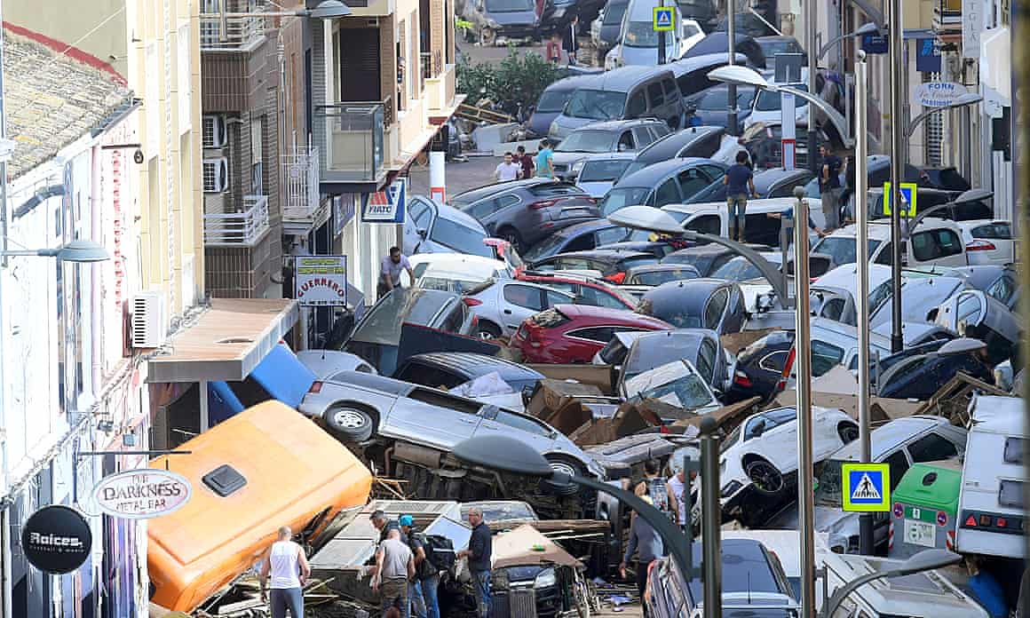 Pedestrians look at piled-up cars