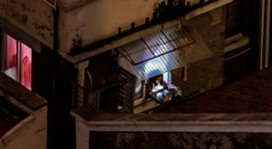 A woman bangs pots outside her window during a protest against the Covid-19 lockdown conditions in Shanghai.