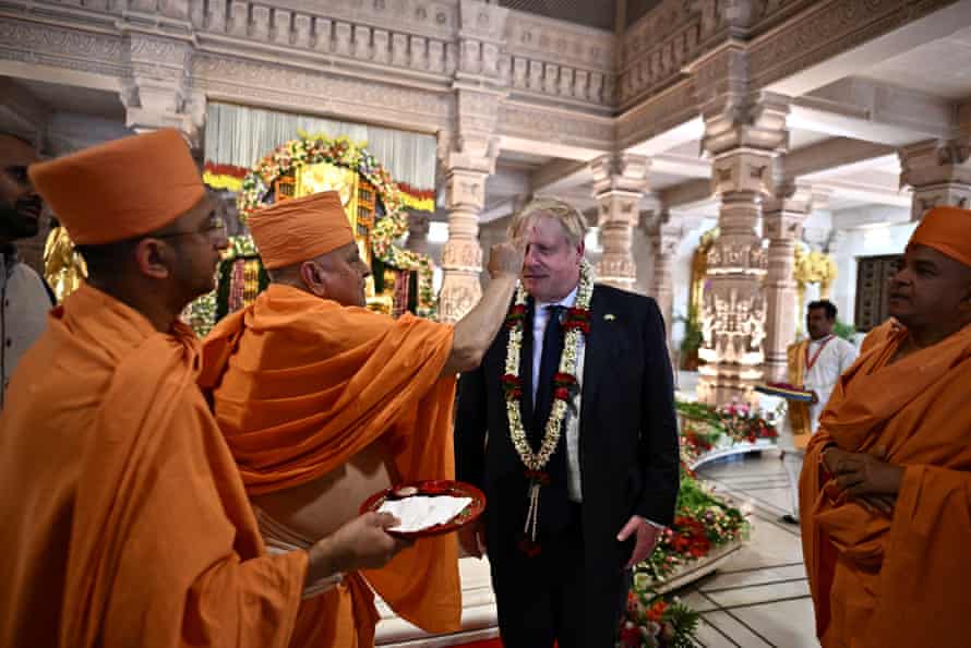 A sadhu or Hindu holyman putting a traditional ‘tilak’ on the forehead of Boris Johnson during his visit at the Swaminarayan Akshardham temple in Gandhinagar, India, today.
