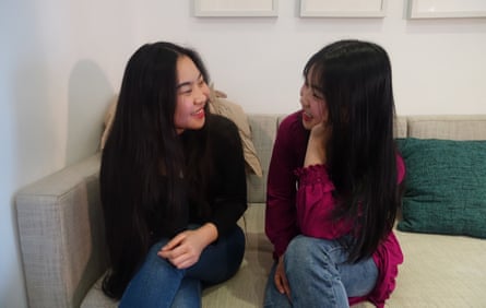 Chinese twins Esther and Shuangjie, facing each other