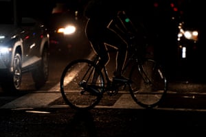 A naked cyclist crosses an intersection