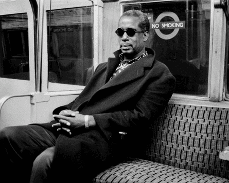 a man wearing sunglasses late night on the underground