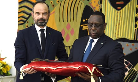 Senegal president Macky Sall, right, receiving the sword that belonged to Omar Saidou Tall from French prime minister Édouard Philippe in 2019.
