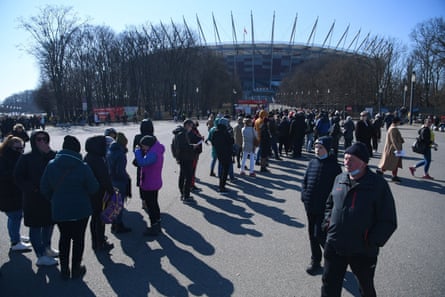 Refugees from Ukraine queue to be given a national identification number at the National Stadium in Warsaw, Poland, 20 March.