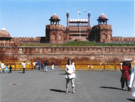 a woman poses in front of the Red Fort in India