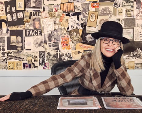 Woman smiles while seated at desk in front of pin board