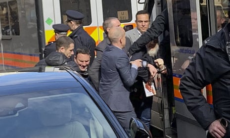 Julian Assange is bundled into a police van after his arrest last week