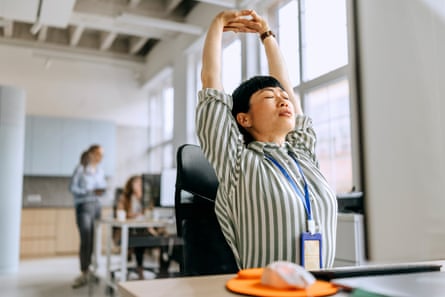 Woman stretching while working in the office