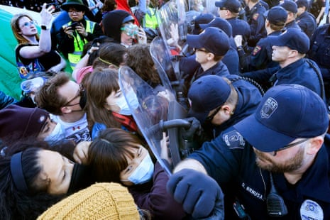 Law enforcement personnel clash with demonstrators.