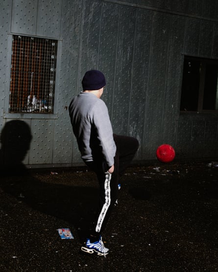 A boy stands in a prison yard