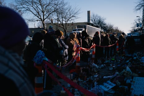 A group of people gather around a memorial site