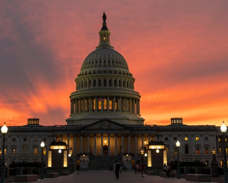 The sun sets behind the US Capitol in Washington.