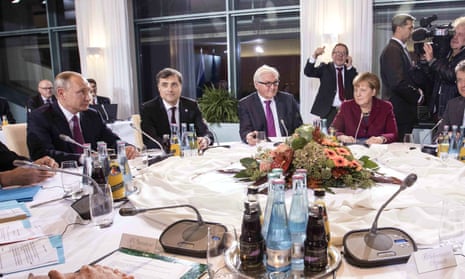 Vladislav Surkov sits next to Vladimir Putin, and two down from Angela Merkel at talks to discuss the situation in Ukraine.