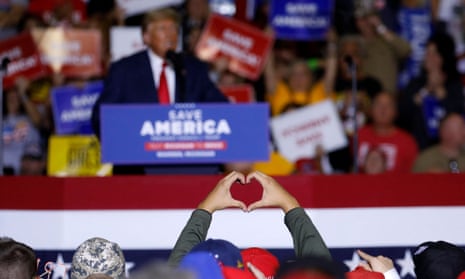 TOPSHOT-US-POLITICS-TRUMP<br>TOPSHOT - A man gestures a heart shape with his hands as former US President Donald Trump speaks during a Save America rally at Macomb County Community College Sports and Expo Center in Warren, Michigan, on October 1, 2022. (Photo by JEFF KOWALSKY / AFP) (Photo by JEFF KOWALSKY/AFP via Getty Images)
