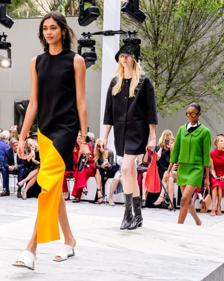 Models walking along a catwalk in the garden of MoMA